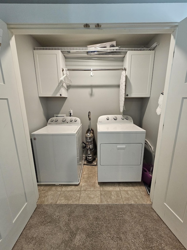 6005 Sentinel Dr, Spring Hill, TN 37174 - laundry area featuring cabinet space, washer and dryer, light tile patterned floors, and light carpet