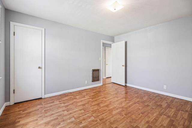 810 Country Club Dr, Clarksville, TN 37043 - empty room with light wood finished floors and heating unit
