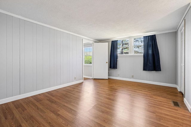 810 Country Club Dr, Clarksville, TN 37043 - empty room featuring a textured ceiling, wood finished floors, and ornamental molding