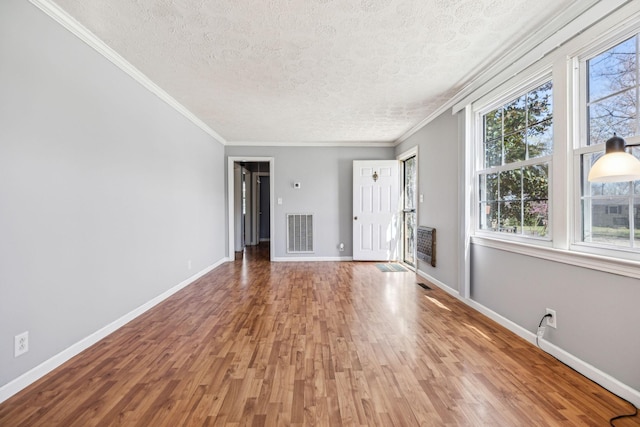 810 Country Club Dr, Clarksville, TN 37043 - unfurnished living room featuring a textured ceiling, wood finished floors, crown molding, and heating unit