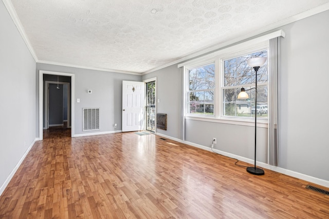 810 Country Club Dr, Clarksville, TN 37043 - unfurnished living room featuring ornamental molding, light wood-type flooring, and a textured ceiling