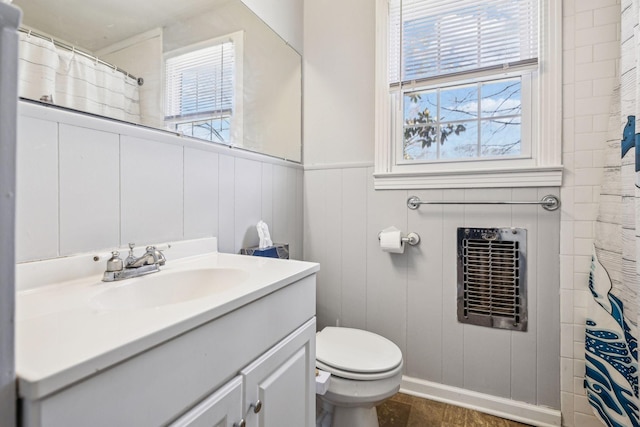 810 Country Club Dr, Clarksville, TN 37043 - bathroom featuring heating unit, vanity, a decorative wall, a wainscoted wall, and a shower with curtain