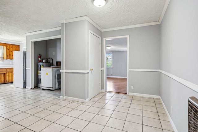 810 Country Club Dr, Clarksville, TN 37043 - kitchen with brown cabinets, a textured ceiling, freestanding refrigerator, light tile patterned floors, and light countertops