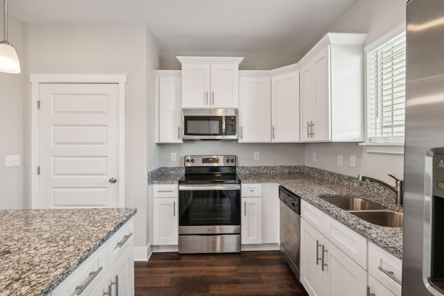 7026 Magnolia Crossings, Spring Hill, TN 37174 - kitchen with appliances with stainless steel finishes, dark wood-type flooring, white cabinetry, and light stone countertops