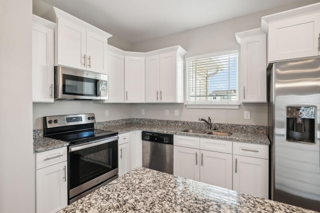 7026 Magnolia Crossings, Spring Hill, TN 37174 - kitchen featuring stainless steel appliances, white cabinets, and dark stone countertops