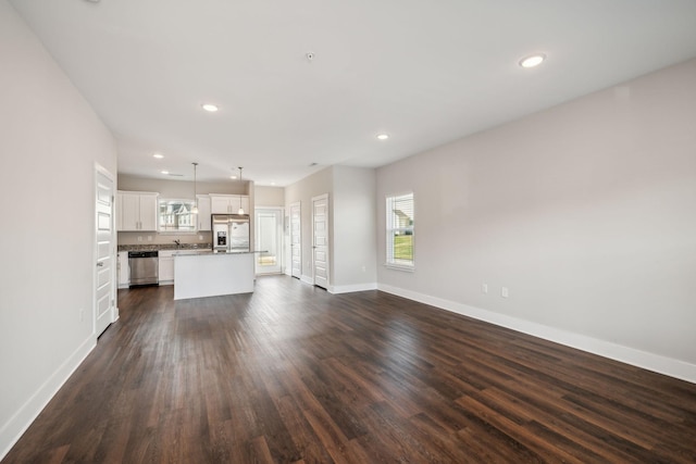 7026 Magnolia Crossings, Spring Hill, TN 37174 - unfurnished living room with plenty of natural light, dark wood-style floors, and recessed lighting