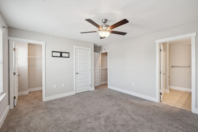 7026 Magnolia Crossings, Spring Hill, TN 37174 - unfurnished bedroom with carpet floors, ensuite bathroom, ceiling fan, and two closets