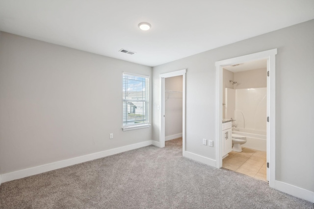 7026 Magnolia Crossings, Spring Hill, TN 37174 - unfurnished bedroom with light colored carpet, a spacious closet, a closet, and ensuite bath