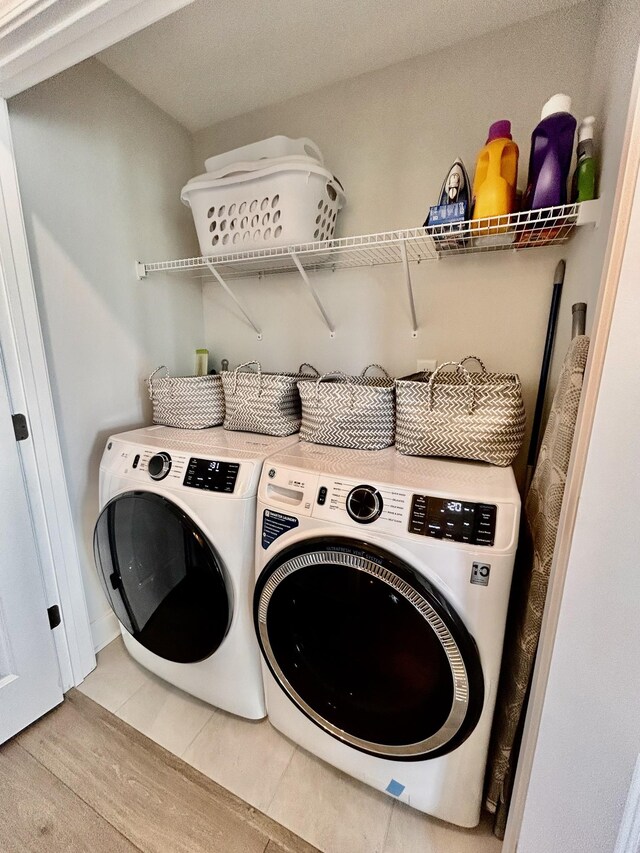 1000 June Wilde Rdg, Spring Hill, TN 37174 - washroom featuring washing machine and clothes dryer and light wood-style flooring