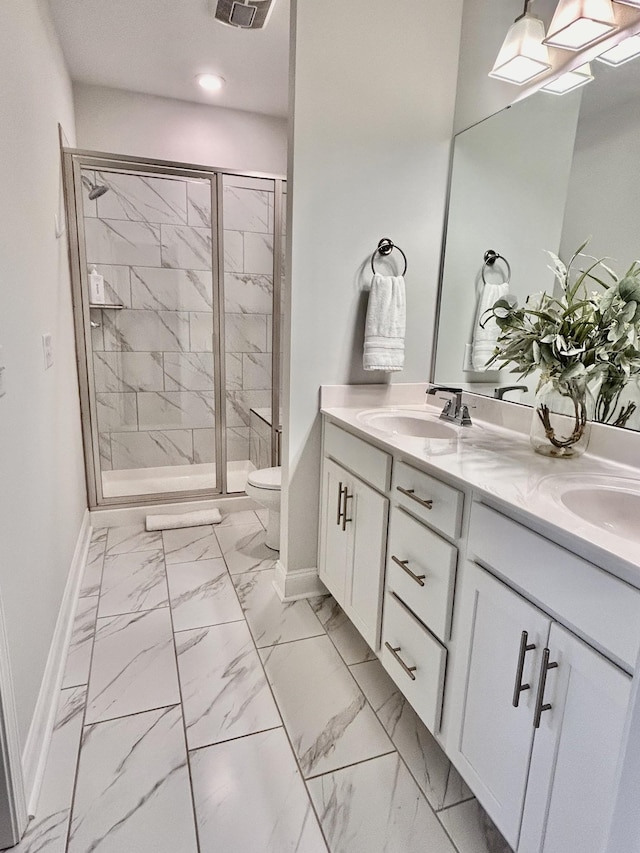 1000 June Wilde Rdg, Spring Hill, TN 37174 - bathroom featuring double vanity, marble look tile flooring, a shower stall, and recessed lighting