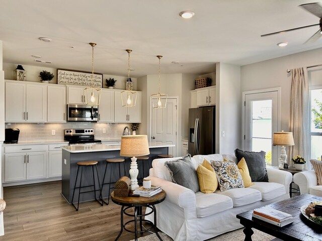 1000 June Wilde Rdg, Spring Hill, TN 37174 - living area with wood finished floors, a ceiling fan, and recessed lighting