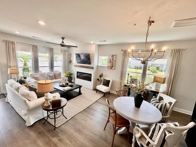 1000 June Wilde Rdg, Spring Hill, TN 37174 - living room with a chandelier, a large fireplace, dark wood-style flooring, ceiling fan, and recessed lighting