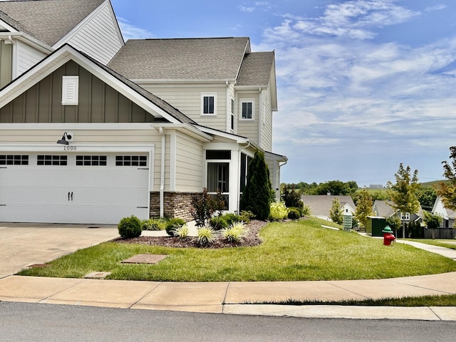 1000 June Wilde Rdg, Spring Hill, TN 37174 - craftsman-style house with driveway, a front yard, an attached garage, roof with shingles, and stone siding