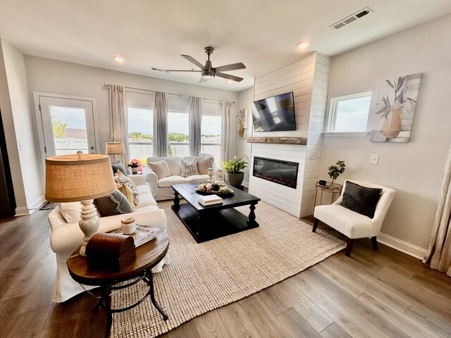 1000 June Wilde Rdg, Spring Hill, TN 37174 - living room with a large fireplace, ceiling fan, wood finished floors, and recessed lighting