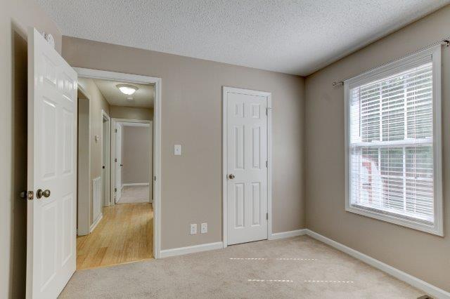 421 Woodale Dr, Clarksville, TN 37042 - unfurnished bedroom with a textured ceiling, light colored carpet, and a closet