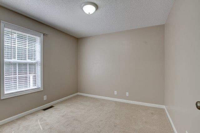421 Woodale Dr, Clarksville, TN 37042 - spare room with a textured ceiling and light carpet