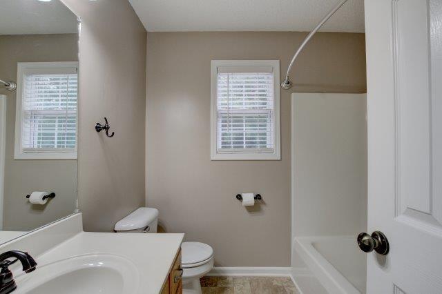 421 Woodale Dr, Clarksville, TN 37042 - bathroom with healthy amount of natural light, vanity, and bathtub / shower combination