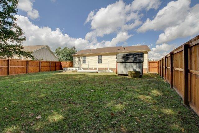 421 Woodale Dr, Clarksville, TN 37042 - rear view of house with a fenced backyard and a storage unit