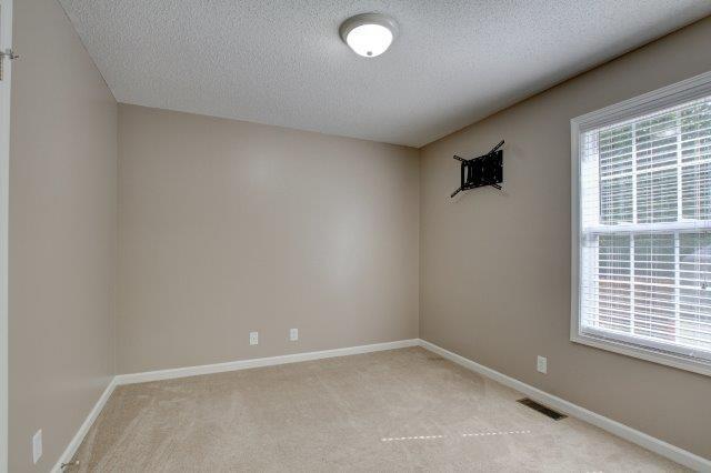 421 Woodale Dr, Clarksville, TN 37042 - empty room featuring a textured ceiling and light colored carpet