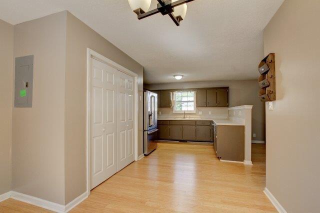421 Woodale Dr, Clarksville, TN 37042 - kitchen with electric panel, light wood-style flooring, light countertops, and stainless steel refrigerator with ice dispenser