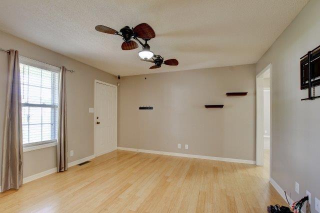 421 Woodale Dr, Clarksville, TN 37042 - unfurnished room with light wood-style floors, a ceiling fan, and a textured ceiling