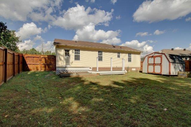 421 Woodale Dr, Clarksville, TN 37042 - rear view of property featuring a shed, a fenced backyard, and a deck