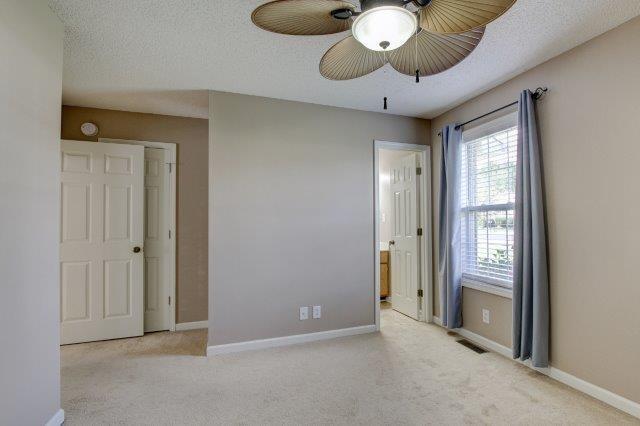 421 Woodale Dr, Clarksville, TN 37042 - unfurnished bedroom with carpet, ensuite bath, and a textured ceiling