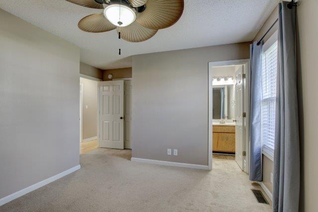 421 Woodale Dr, Clarksville, TN 37042 - unfurnished bedroom featuring carpet flooring, ensuite bath, and a ceiling fan