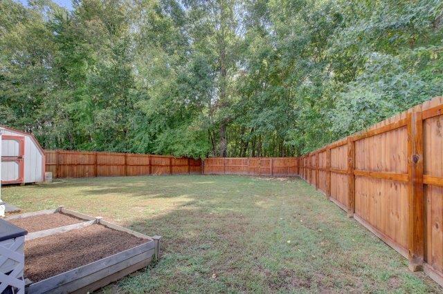 421 Woodale Dr, Clarksville, TN 37042 - fenced backyard with a storage shed and a vegetable garden
