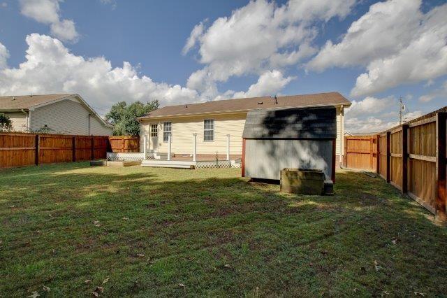 421 Woodale Dr, Clarksville, TN 37042 - rear view of property featuring a storage unit, a wooden deck, and a fenced backyard