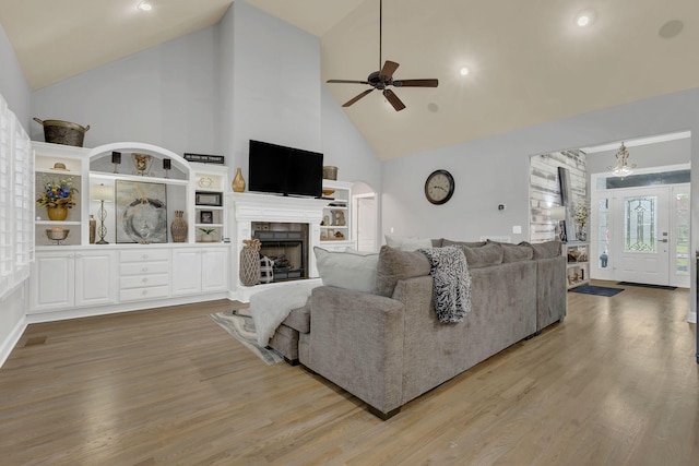 2005 Windsong Dr, Spring Hill, TN 37174 - living area featuring high vaulted ceiling, a ceiling fan, wood finished floors, a fireplace with raised hearth, and recessed lighting