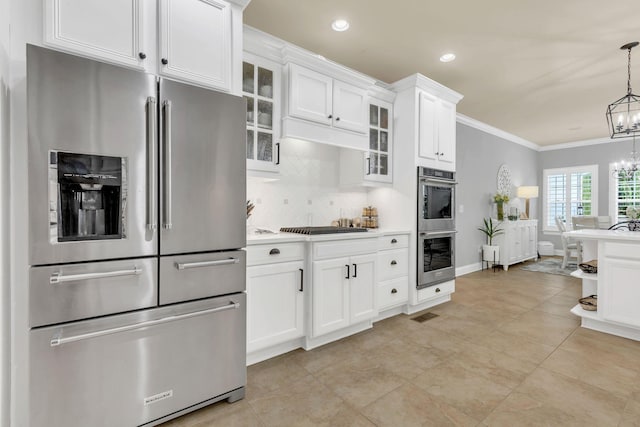 2005 Windsong Dr, Spring Hill, TN 37174 - kitchen featuring stainless steel appliances, a chandelier, backsplash, ornamental molding, and light countertops
