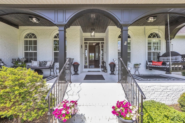 2005 Windsong Dr, Spring Hill, TN 37174 - doorway to property featuring covered porch and brick siding