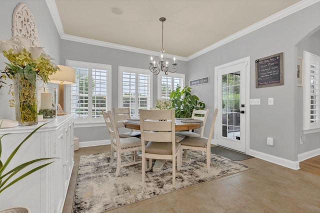 2005 Windsong Dr, Spring Hill, TN 37174 - dining space featuring ornamental molding, a chandelier, healthy amount of natural light, light tile patterned floors, and arched walkways