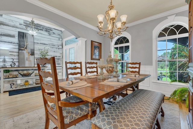 2005 Windsong Dr, Spring Hill, TN 37174 - dining area featuring a chandelier, light wood-style flooring, arched walkways, and ornamental molding