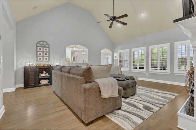 2005 Windsong Dr, Spring Hill, TN 37174 - living room featuring arched walkways, high vaulted ceiling, ceiling fan, and wood finished floors
