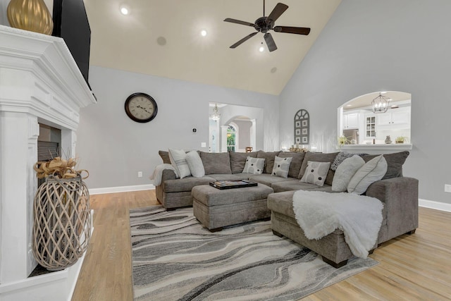 2005 Windsong Dr, Spring Hill, TN 37174 - living room with arched walkways, ceiling fan, high vaulted ceiling, wood finished floors, and a chandelier