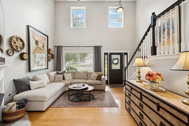 3232 Dark Woods Dr, Franklin, TN 37064 - living room featuring a high ceiling, light wood-style floors, plenty of natural light, and stairway