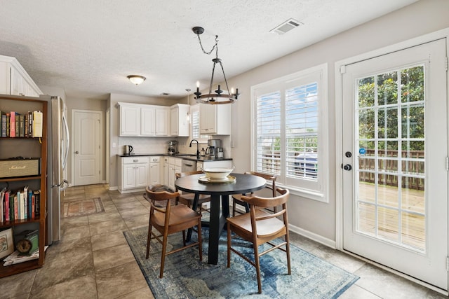 3232 Dark Woods Dr, Franklin, TN 37064 - dining room featuring plenty of natural light, a textured ceiling, and a chandelier