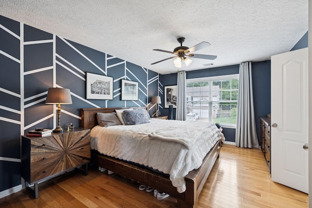 3232 Dark Woods Dr, Franklin, TN 37064 - bedroom featuring light wood-style floors, a textured ceiling, and a ceiling fan