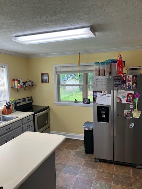 117 Willow St N, Cowan, TN 37318 - kitchen featuring appliances with stainless steel finishes, a textured ceiling, plenty of natural light, crown molding, and gray cabinets