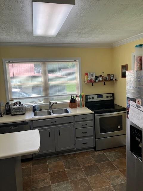 117 Willow St N, Cowan, TN 37318 - kitchen featuring appliances with stainless steel finishes, gray cabinets, plenty of natural light, ornamental molding, and a textured ceiling