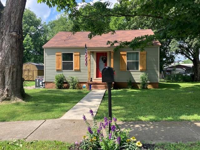 117 Willow St N, Cowan, TN 37318 - view of front of house featuring a storage unit and a front lawn