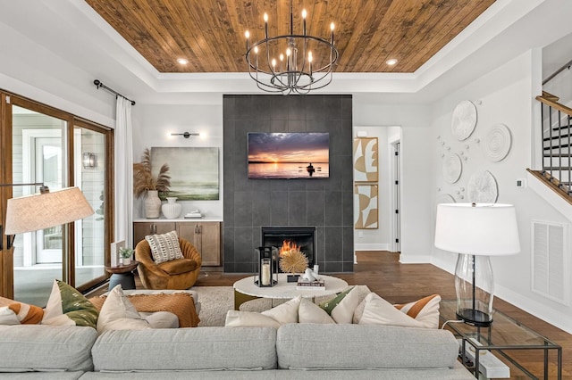 7405 Leelee Dr, Franklin, TN 37064 - living area with wood ceiling, a tray ceiling, stairway, dark wood-style floors, and a tile fireplace
