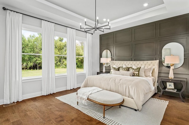 7405 Leelee Dr, Franklin, TN 37064 - bedroom featuring a tray ceiling, a chandelier, a decorative wall, recessed lighting, and dark wood finished floors