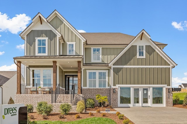 7405 Leelee Dr, Franklin, TN 37064 - view of front of property featuring board and batten siding, brick siding, a standing seam roof, a shingled roof, and a metal roof