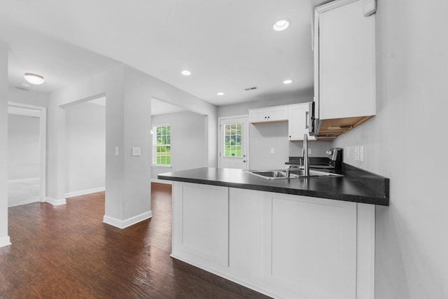 109 Tindell Ln, Columbia, TN 38401 - kitchen with a peninsula, dark countertops, white cabinetry, dark wood-style flooring, and recessed lighting
