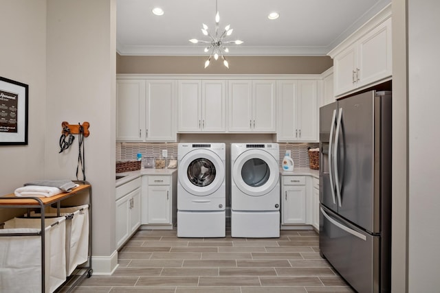 7243 Murrel Dr, Franklin, TN 37064 - laundry room featuring washer and dryer, a chandelier, ornamental molding, recessed lighting, and light wood-type flooring
