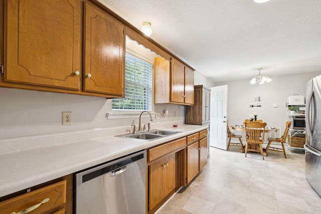 3114 Penny Ln, Murfreesboro, TN 37130 - kitchen with stainless steel appliances, a chandelier, brown cabinetry, and a textured ceiling
