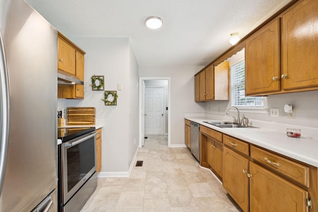 3114 Penny Ln, Murfreesboro, TN 37130 - kitchen featuring stainless steel appliances, under cabinet range hood, light countertops, and brown cabinets